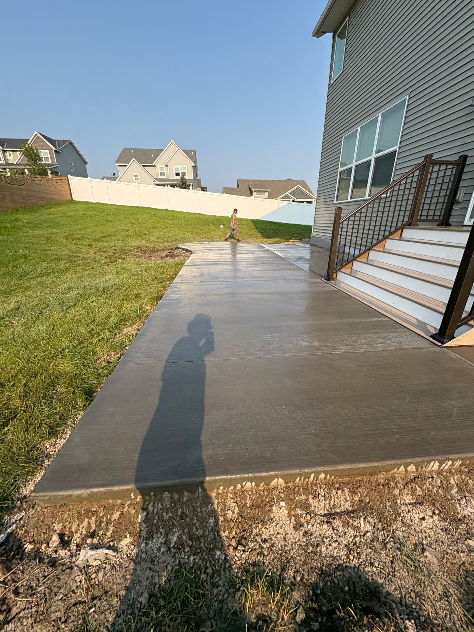Gallery photos for Gray Concrete Patio Installation for a Mud-Free Backyard: Image #1